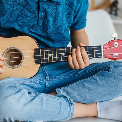 Child playing a ukulele